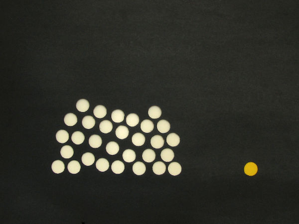 A cluster of very similar white circles are separated from a single, distinct, yellow circle.